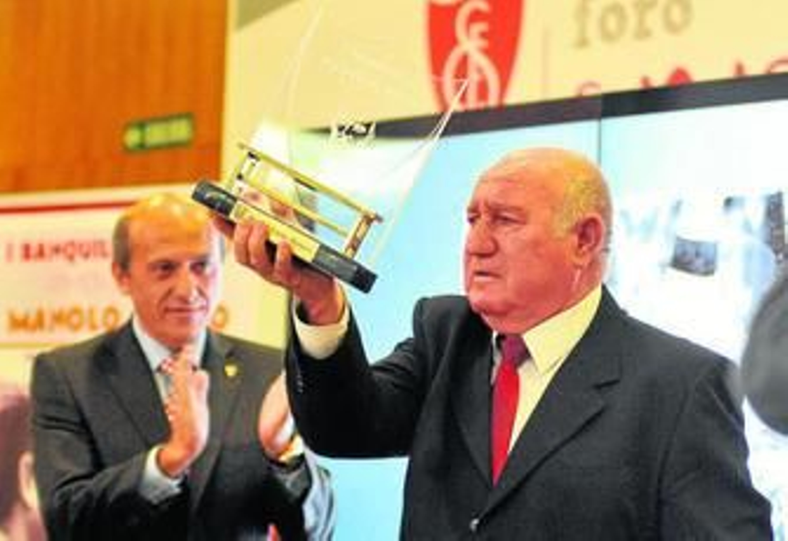 Manolo Cardo, emocionado, recibe el reconocimiento del sevillismo, con Del Nido en segundo plano.
