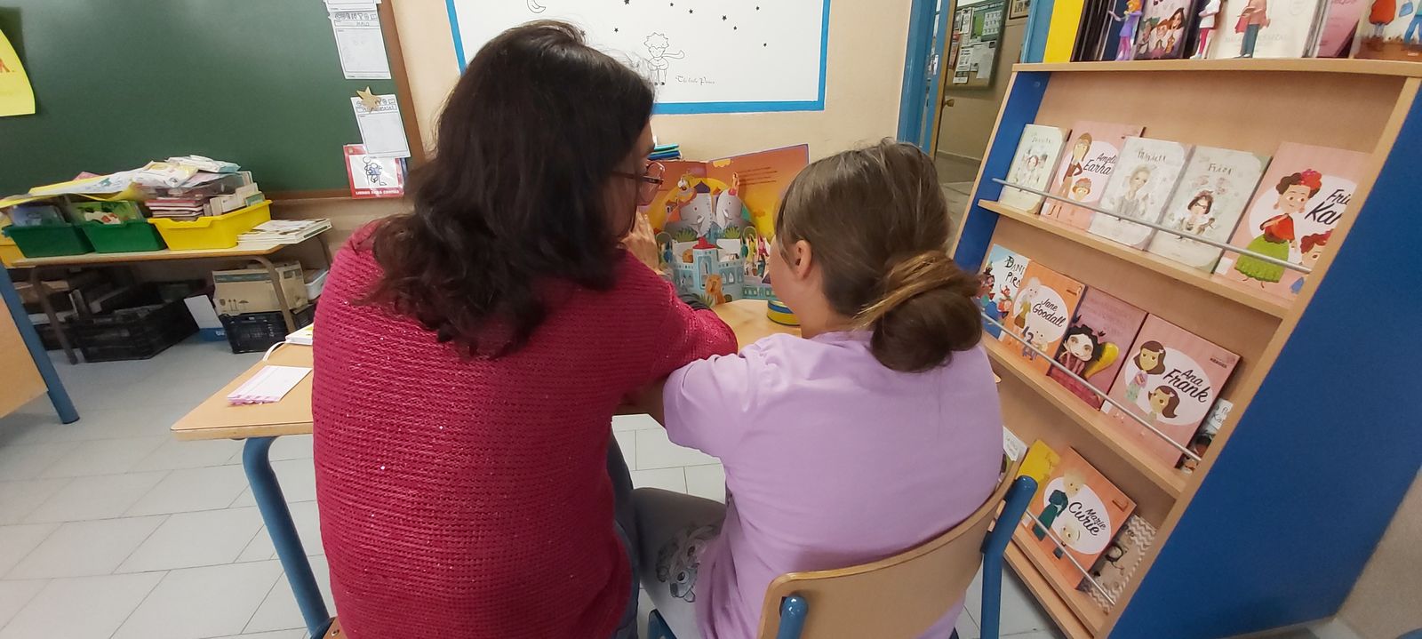 Una voluntaria leyendo con una niña en una de las sesiones de Lecxit.