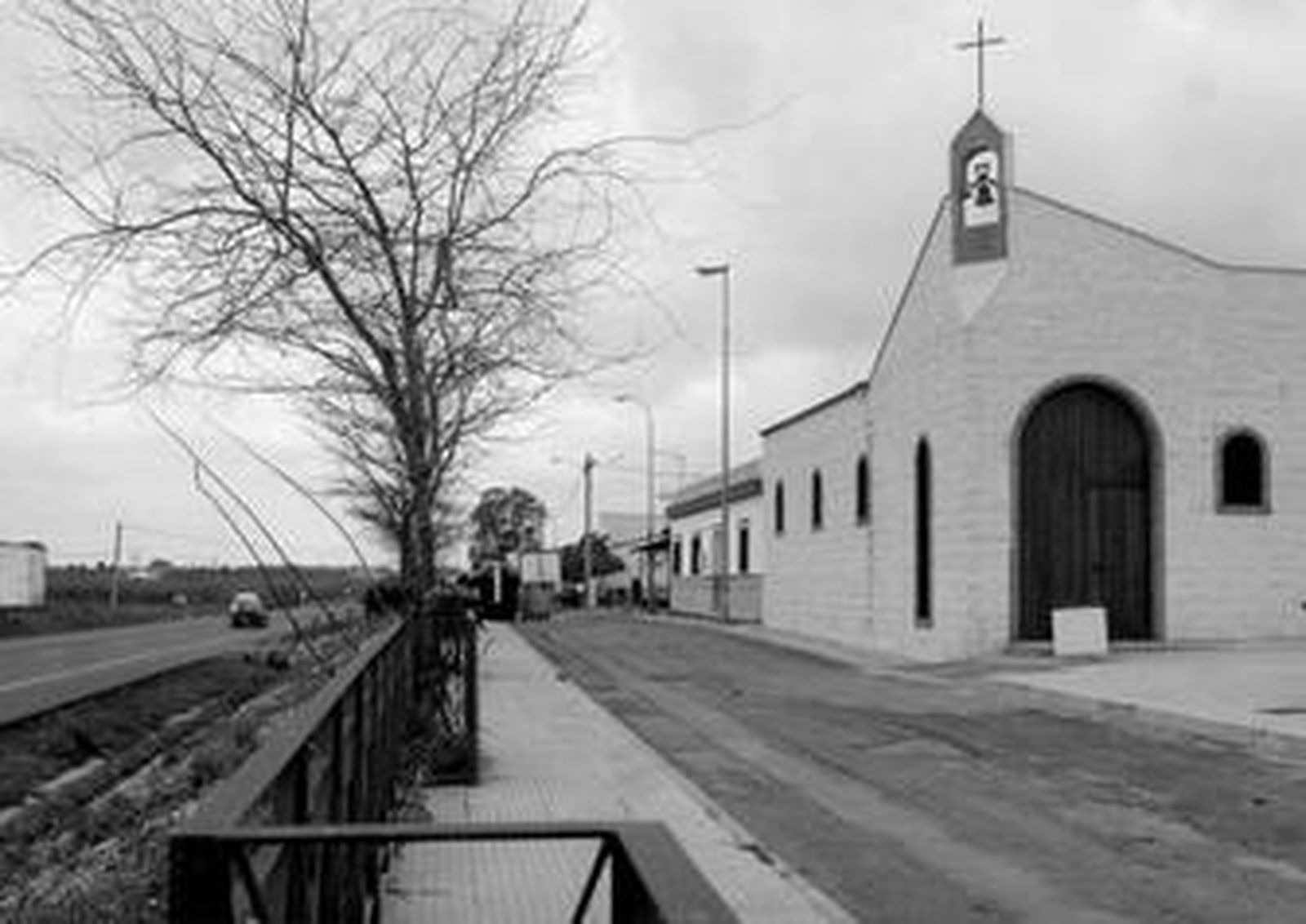Imagen de la primera hilera de viviendas de La Ribera junto a la iglesia del barrio.