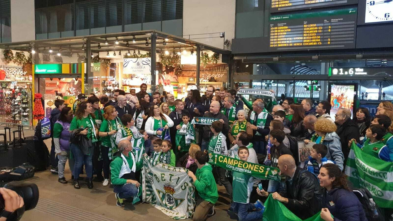 La expedición verdiblanca posa con algunos de los aficionados que fueron a recibir al equipo a Santa Justa.