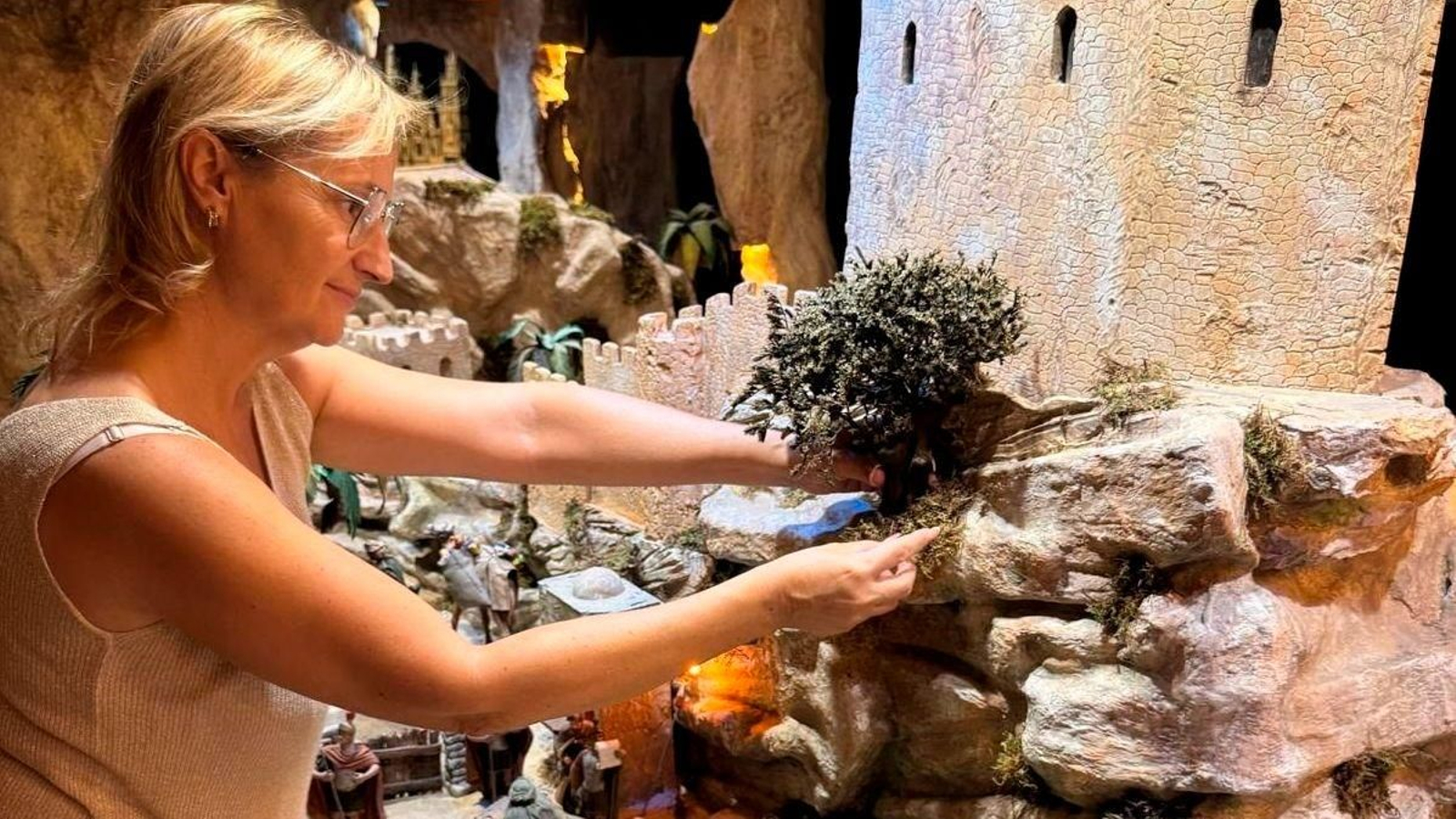 La responsable de preparar este Belén pieza a pieza, Mayka Gómez, con la ayuda de dos artesanos más.