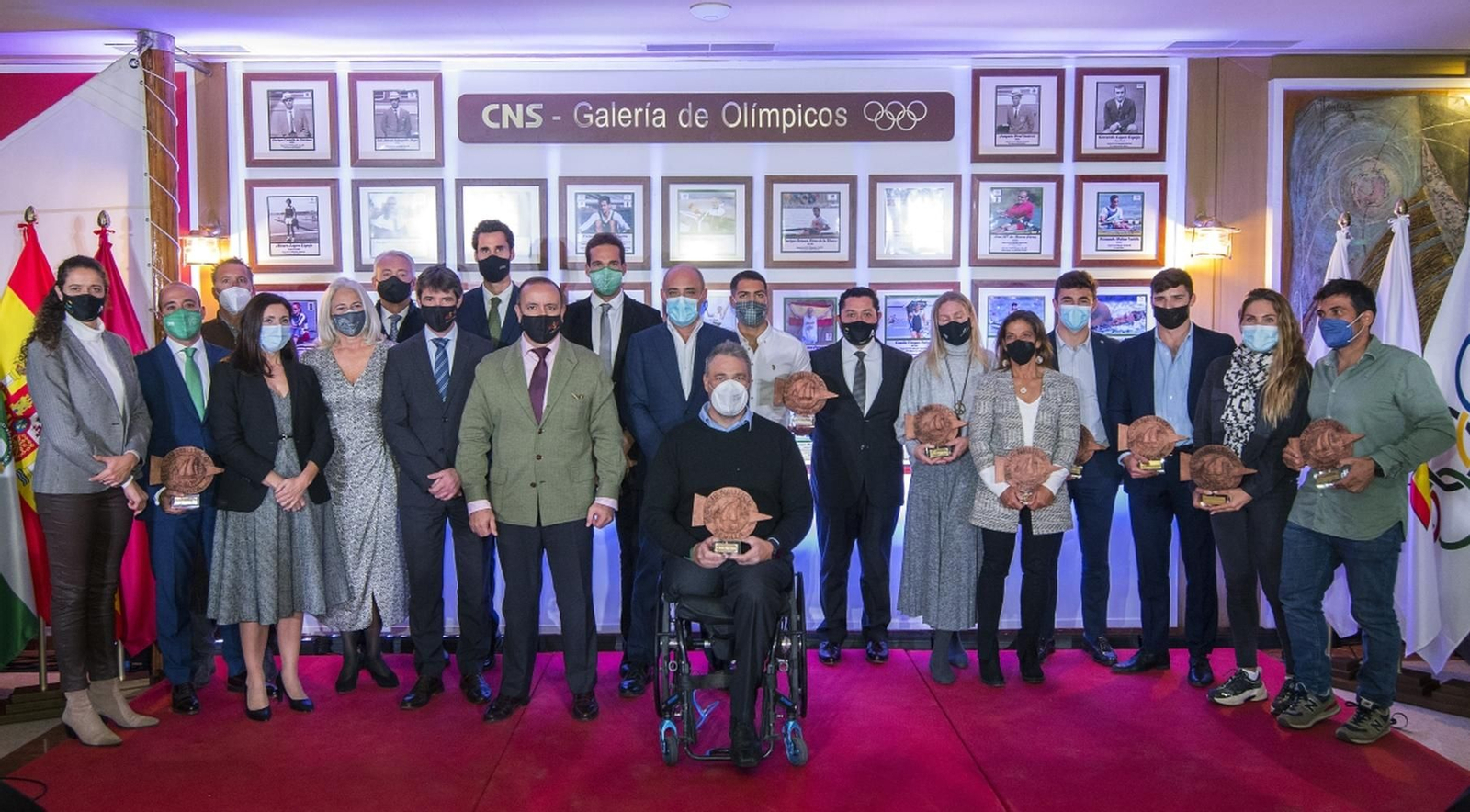 Los deportistas presentes en la cita posan delante de la Galería de Olímpicos del Club Náutico Sevilla.