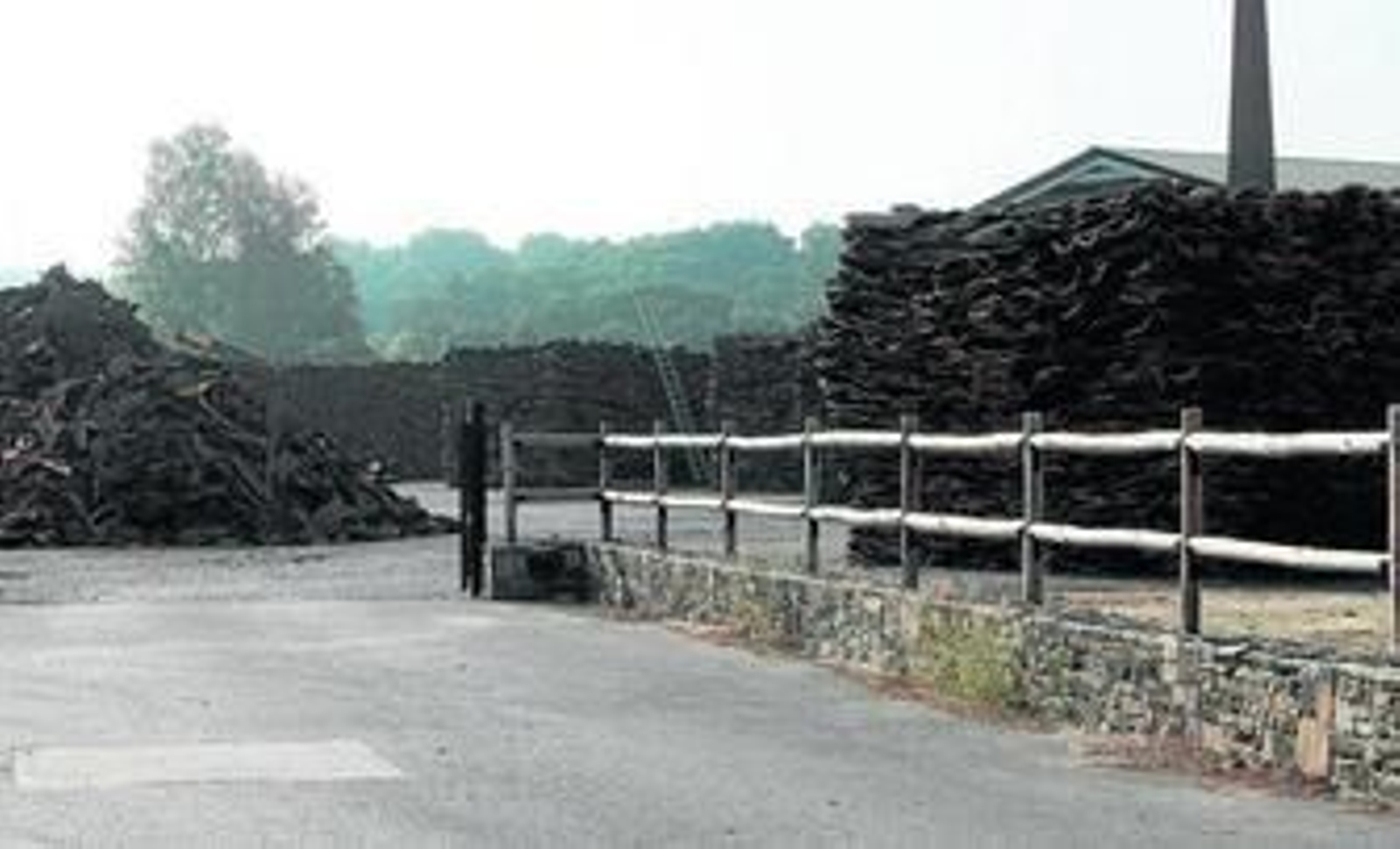 Pilas de corcho extraídas en los montes del latifundio apiladas en el patio de la finca La Almoraima, el pasado viernes.