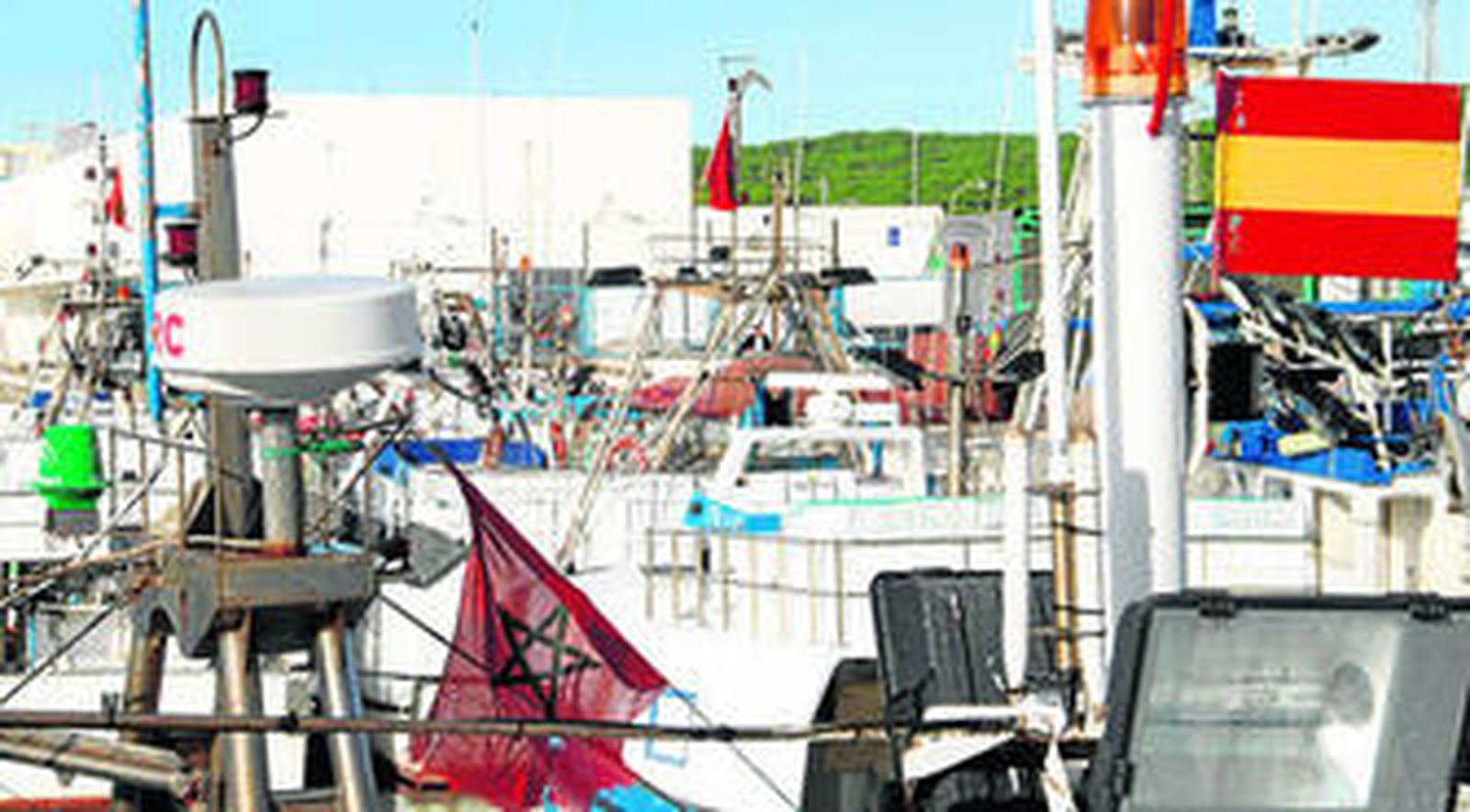 Las banderas española y marroquí ondean en los barcos amarrados en el puerto de La Albufera de Barbate.