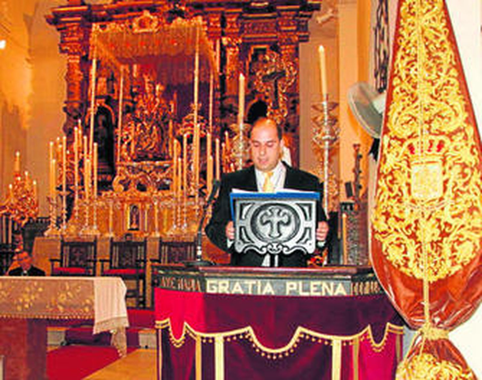 El pregonero, ante el altar del templo de Santo Domingo, con la Virgen de la Bella al fondo.