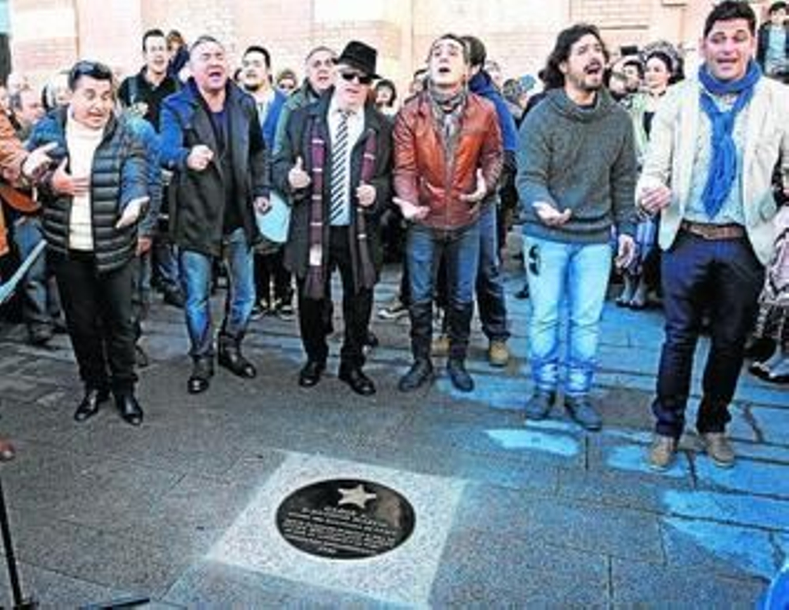 Antonio Martín canta junto a su comparsa justo detrás de la losa descubierta en su honor ante el Falla.