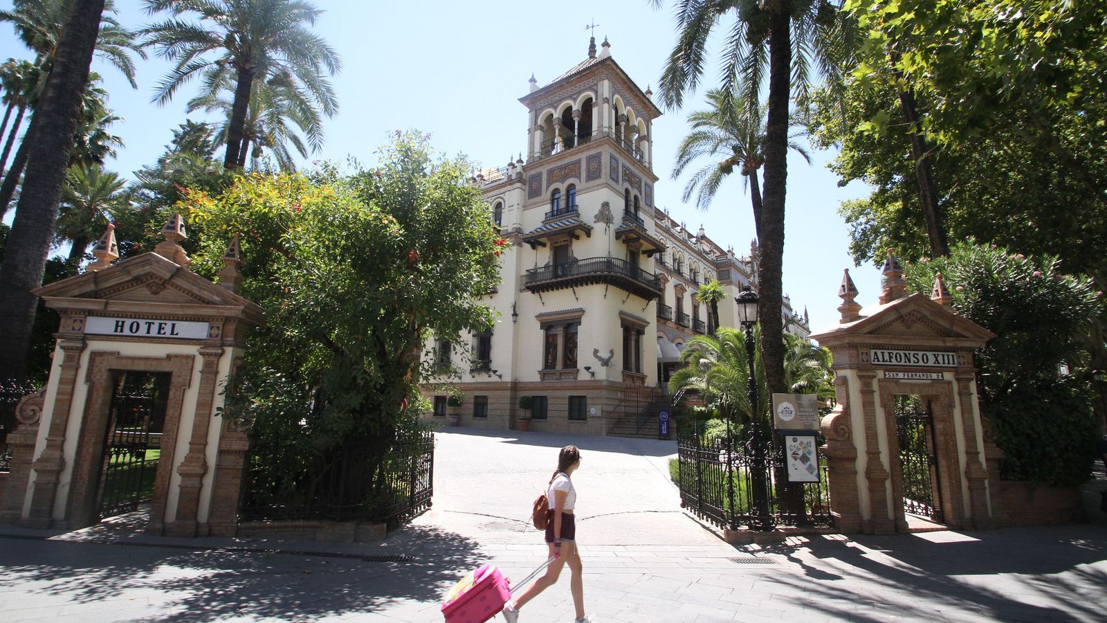 Una joven pasa junto al Hotel Alfonso XIII, en la calle San Fernando.