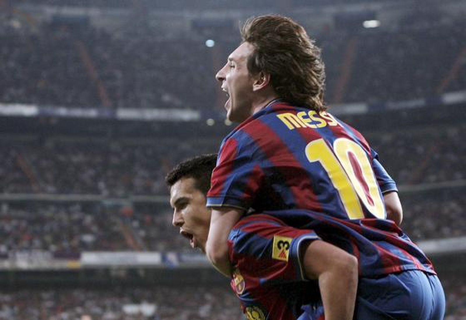 Messi se sube encima de Pedro para festejar el segundo gol. / EFE