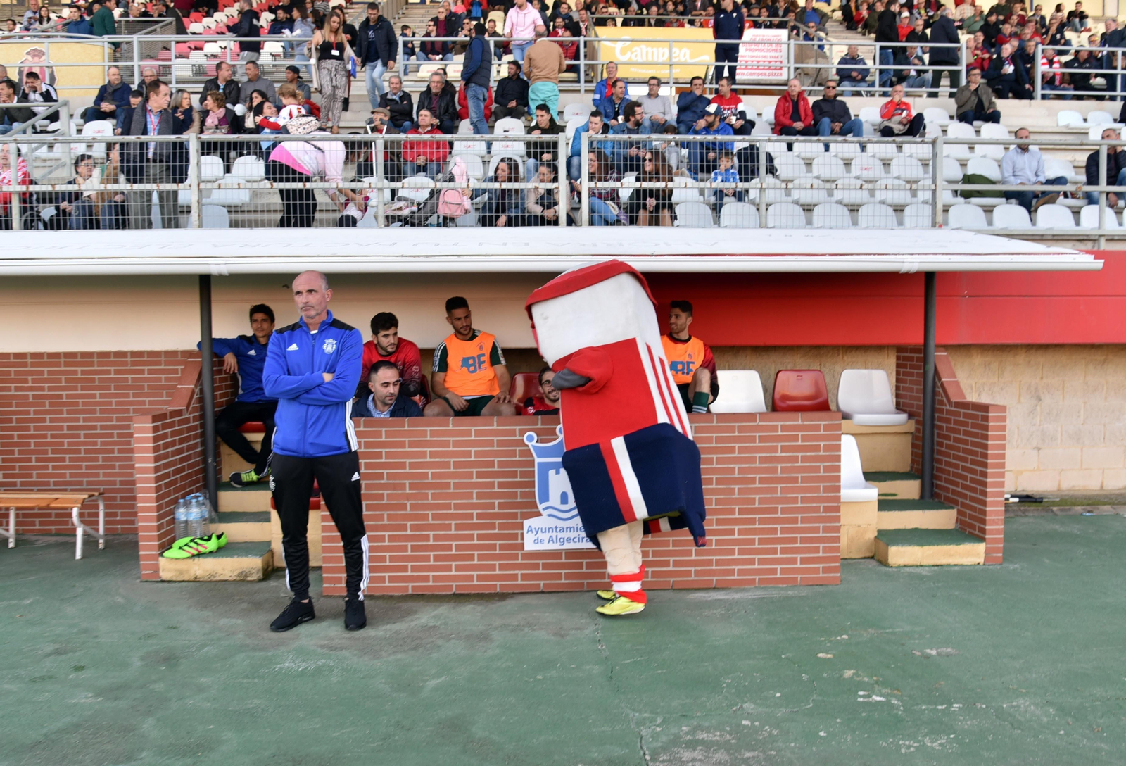 Garrido, técnico del Espeleño, en el Nuevo Mirador junto a la mascota local Miradín.