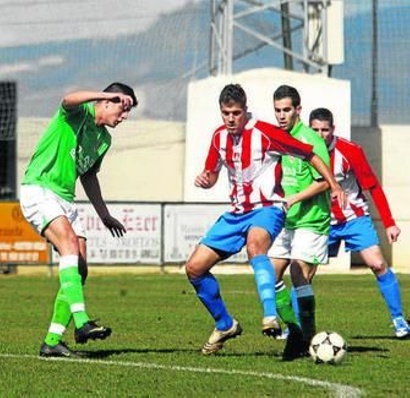 Un jugador del Arenas persigue el cuero ante dos rivales.