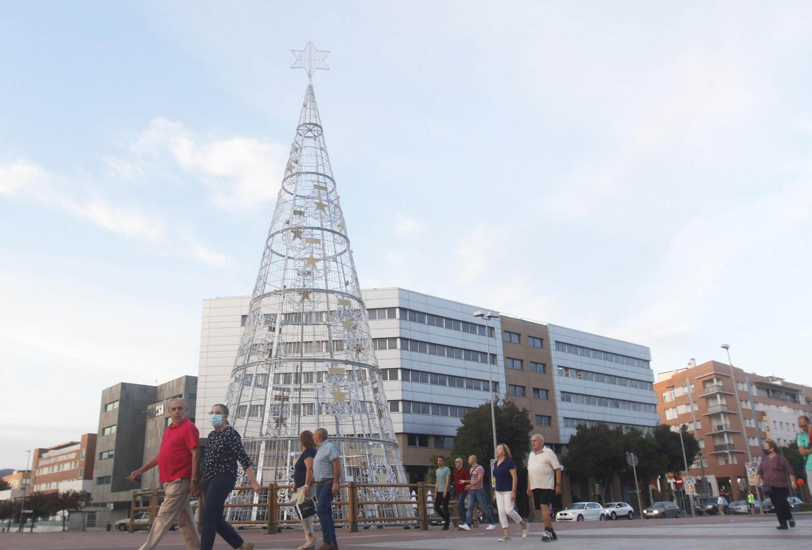 Varias personas caminan haciendo deporte junto al montaje de la plaza de España.