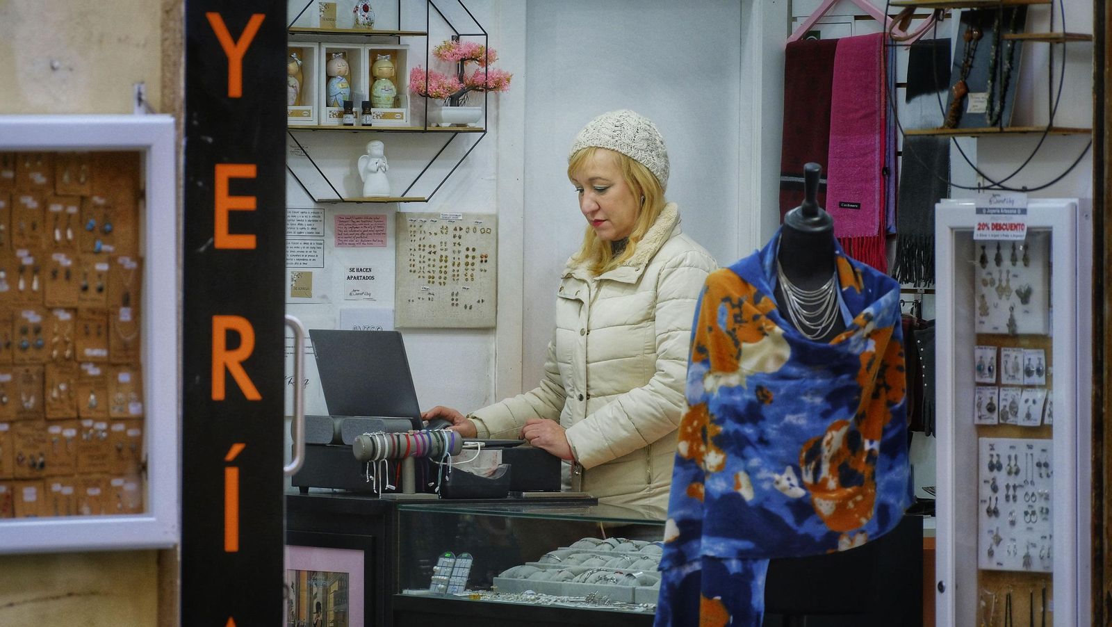 La dependienta de una tienda de Cádiz, trabajando con gorro y anorak.