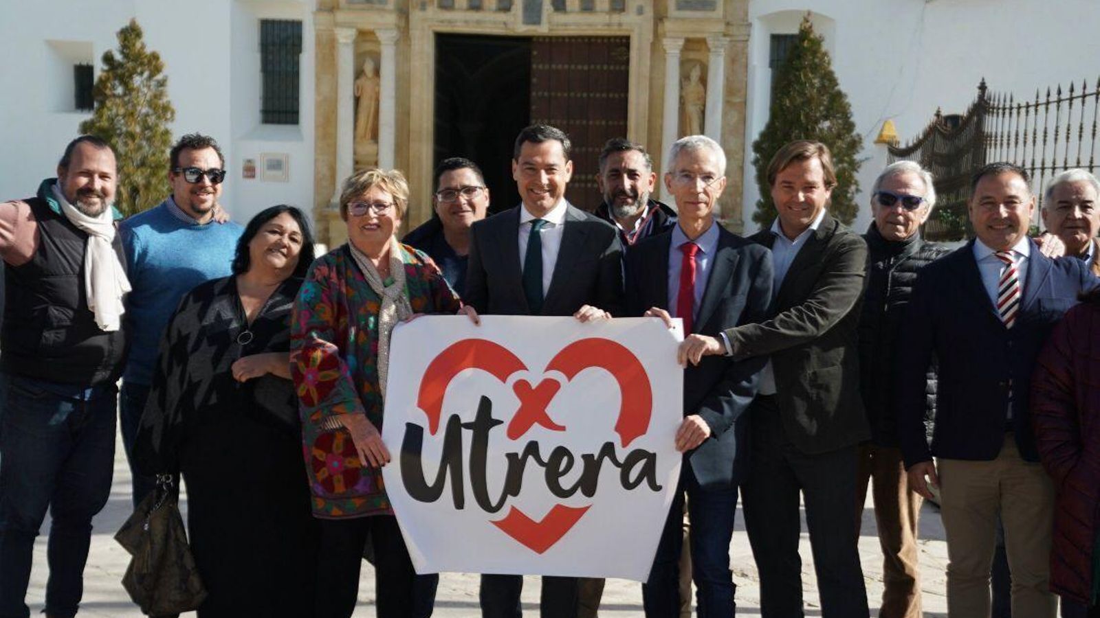 El presidente Moreno, Curro Jiménez, Antonio Repullo, Ricardo Sánchez y otros cargos sostienen la bandera del partido Juntos por Utrera.