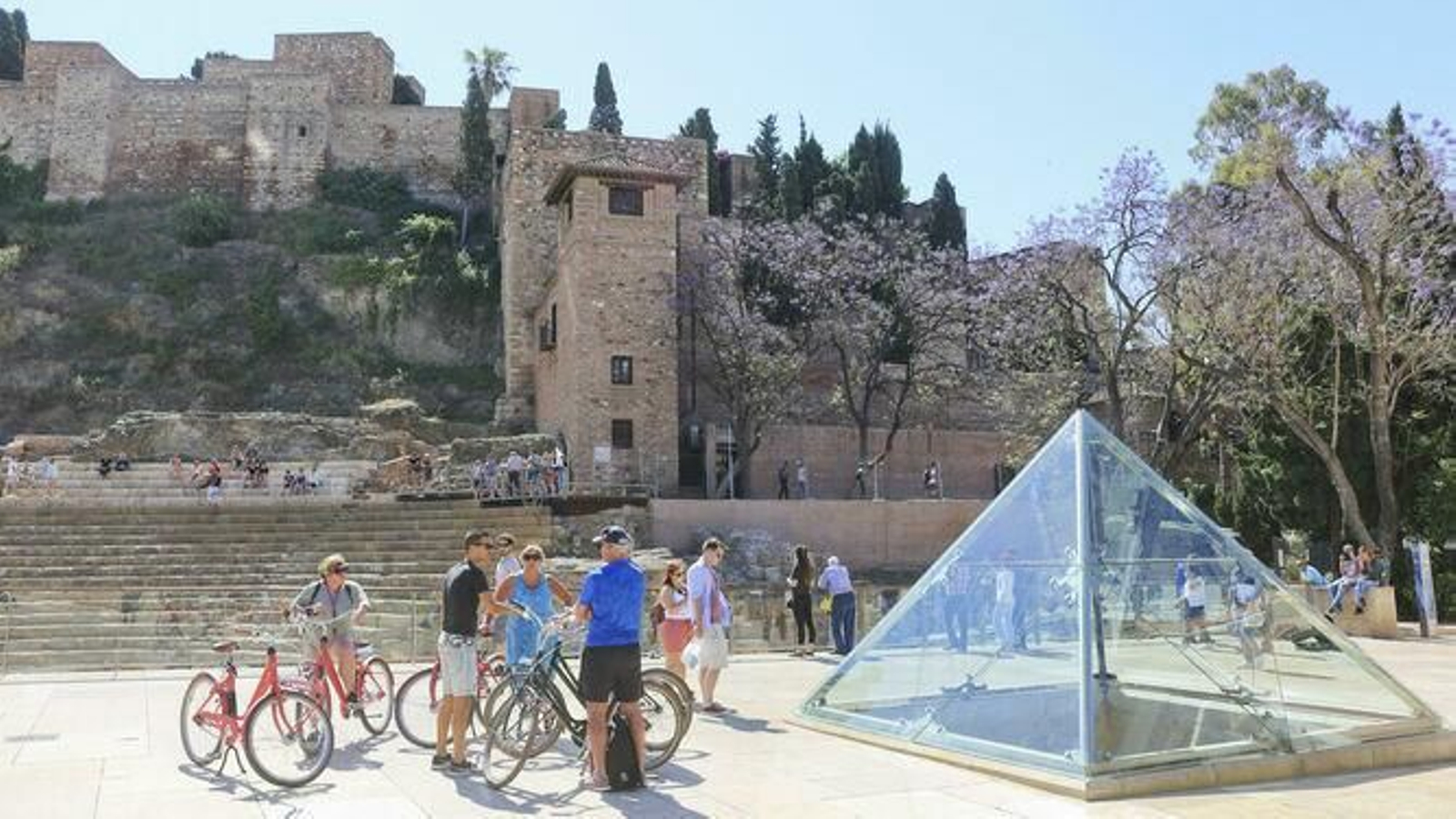 Turistas en la calle Alcazabilla, frente a la Alcazaba y el Teatro Romano.