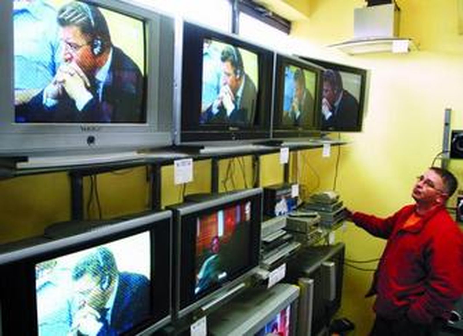 Un trabajador sigue por televisión el juicio a Gotovina desde una tienda de Banja Luka.