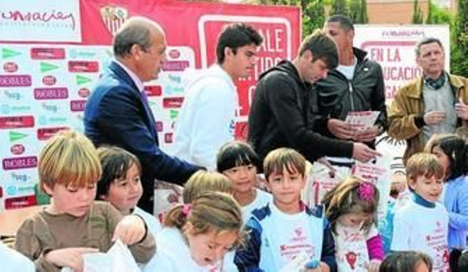 Del Nido, Perotti, Rusescu y Maduro reparten regalos entre los niños del CEIP Luis Cernuda.