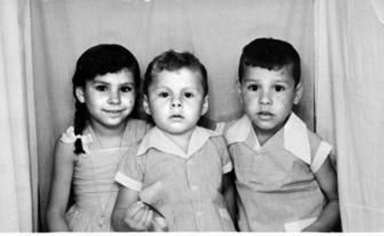 de sus hermanos, María y Manuel.