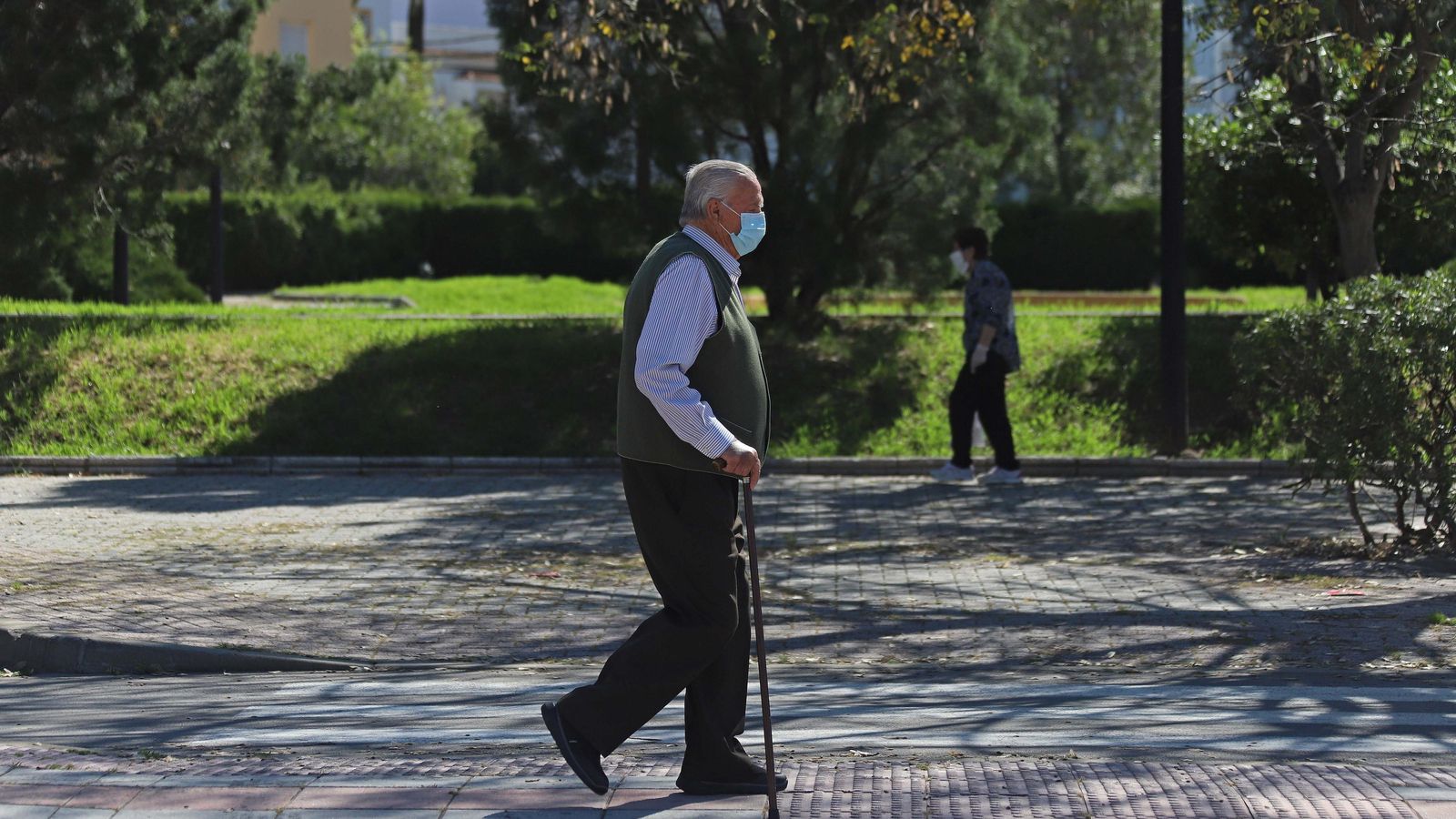 Un anciano con mascarilla pasea por la avenida Tercer Centenario de Los Barrios.