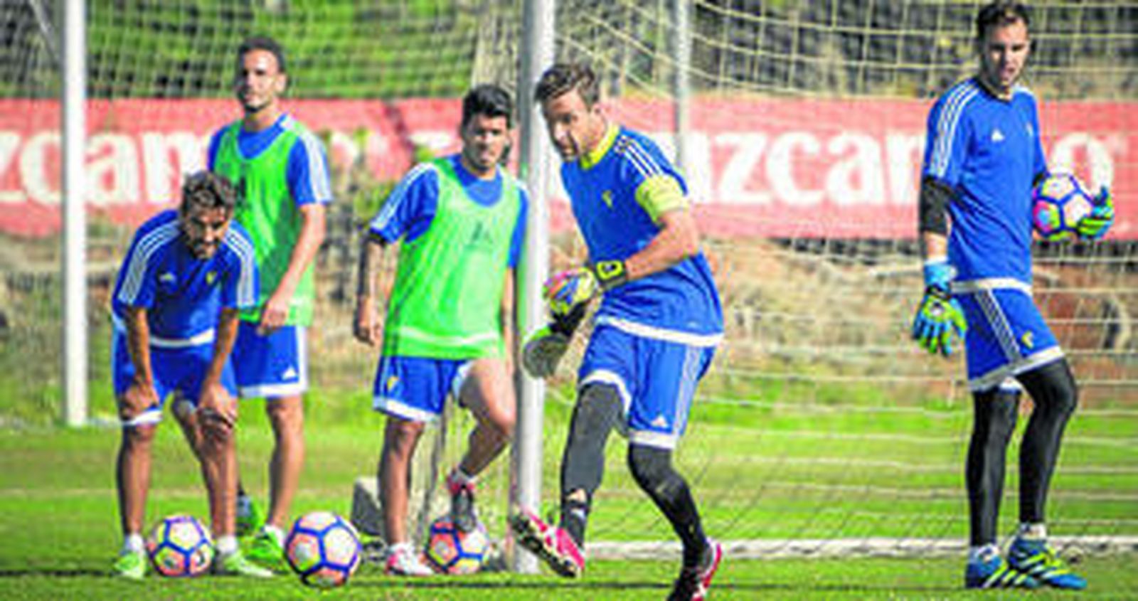 Alberto Cifuentes golpea un balón en un entrenamiento ante la atenta mirada de varios compañeros.