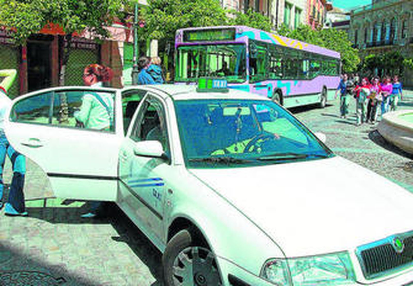 Dos jóvenes se bajan de un taxi en la Rotonda de los Casinos.