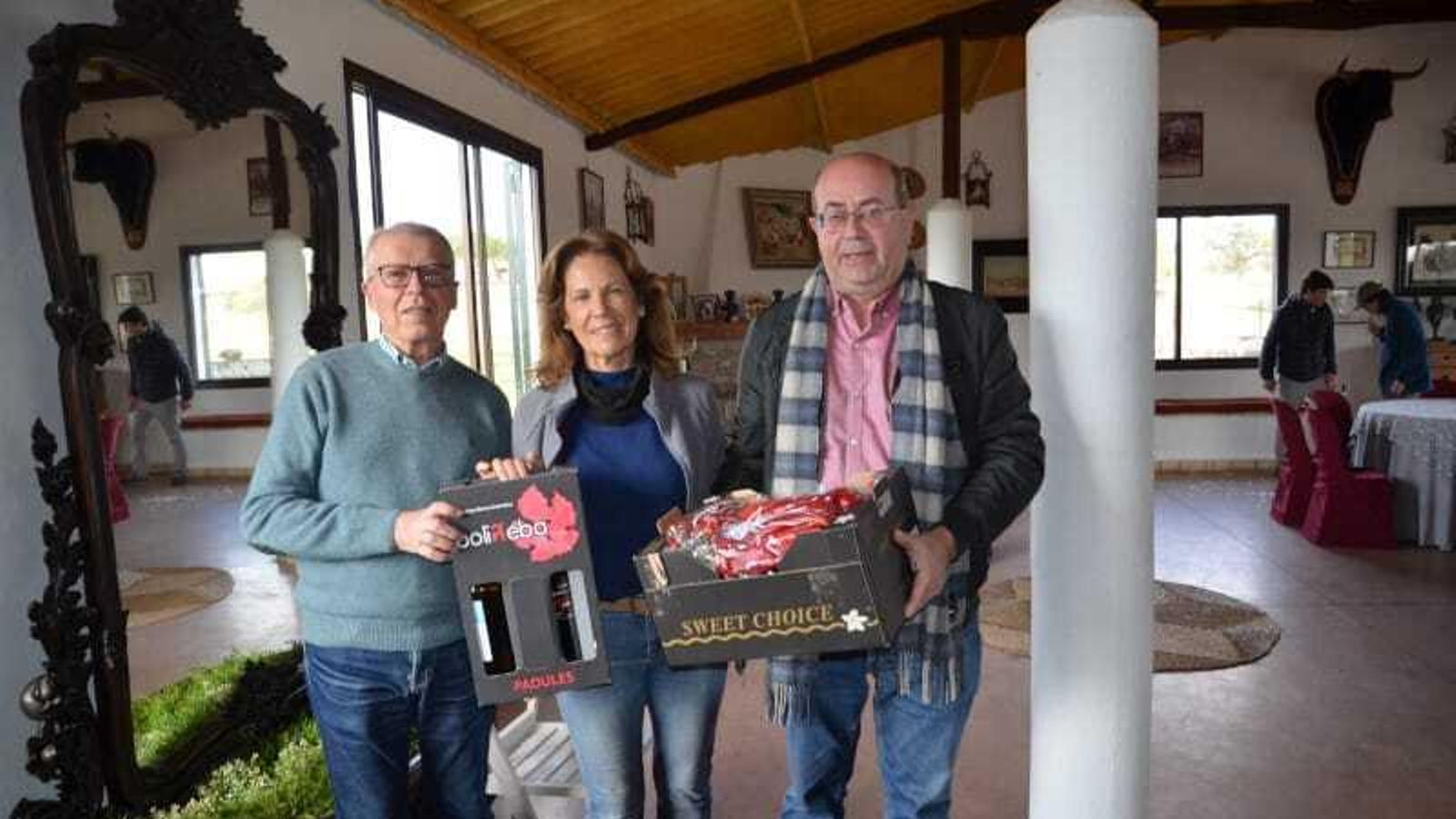 Presidente y secretario del Foro entregan unos regalos a Aurora Algarra.