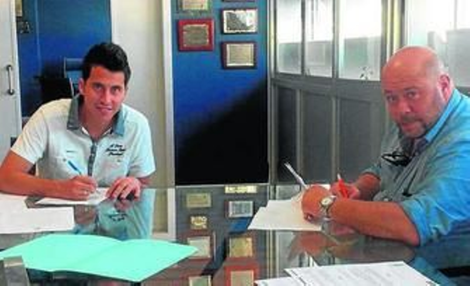 Jorge Larena firma ayer su contrato en presencia de Pablo Comas -derecha-.