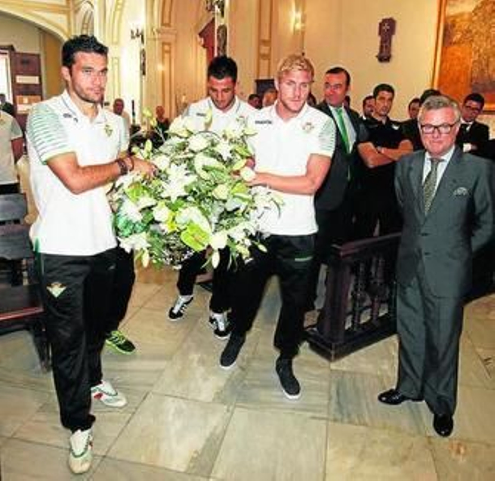 Los capitanes, junto al presidente, realizan la ofrenda floral.