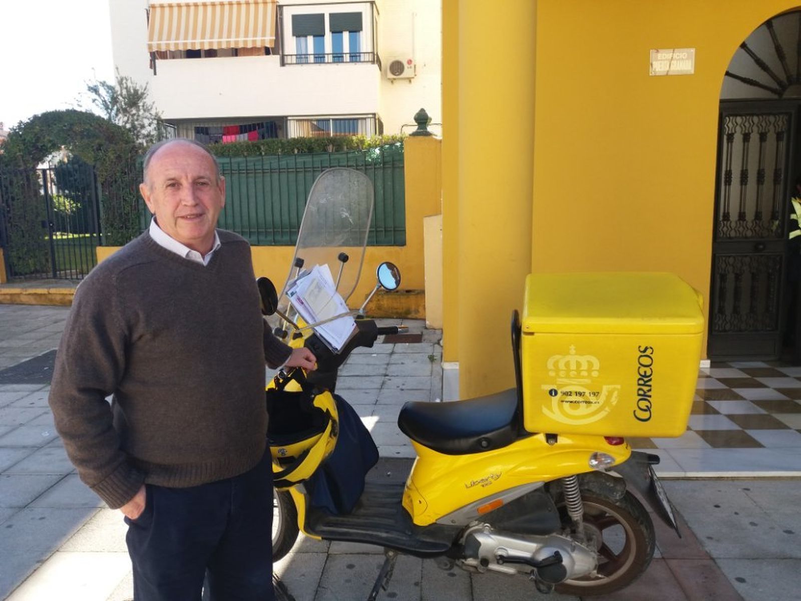 Antonio Funes en la actualidad, junto a una moto de Correos.