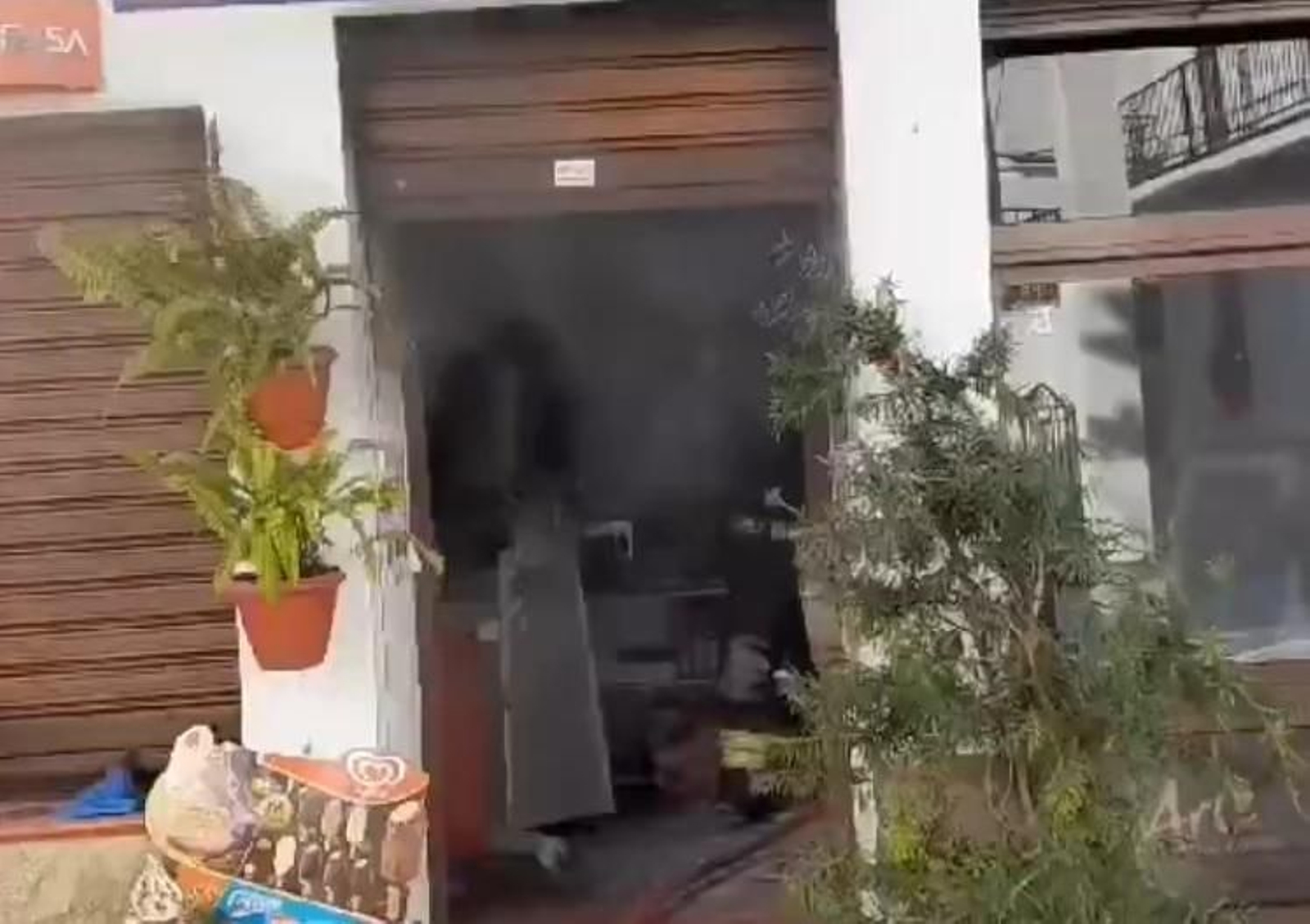 Bomberos sofocando el incendio declarado en el interior de la churrería.