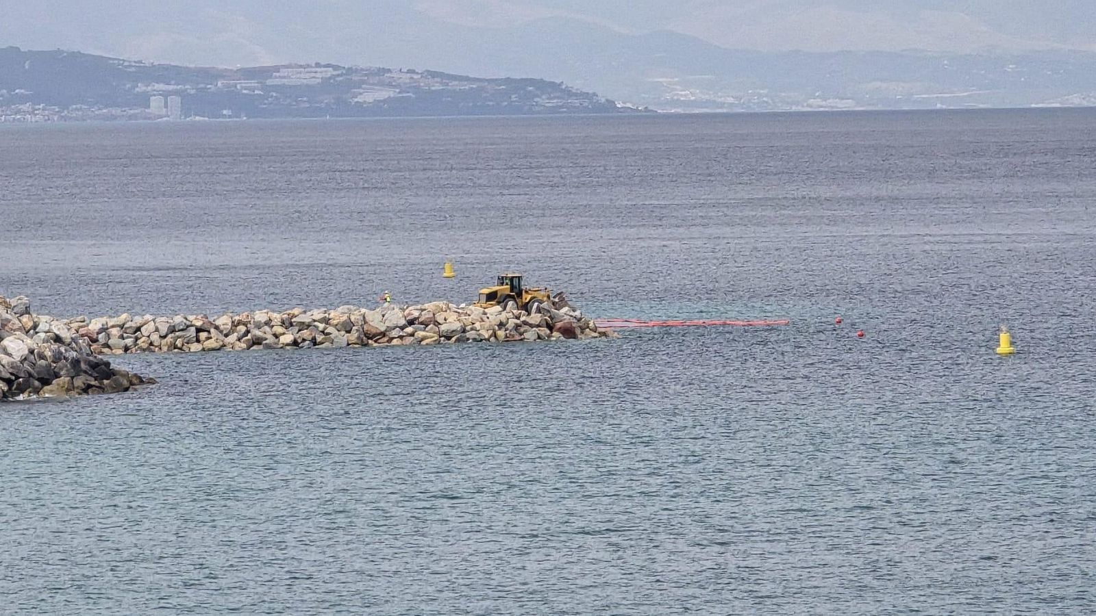 Una excavadora en el extremo del dique del Eastside, este Martes Santo por la tarde.