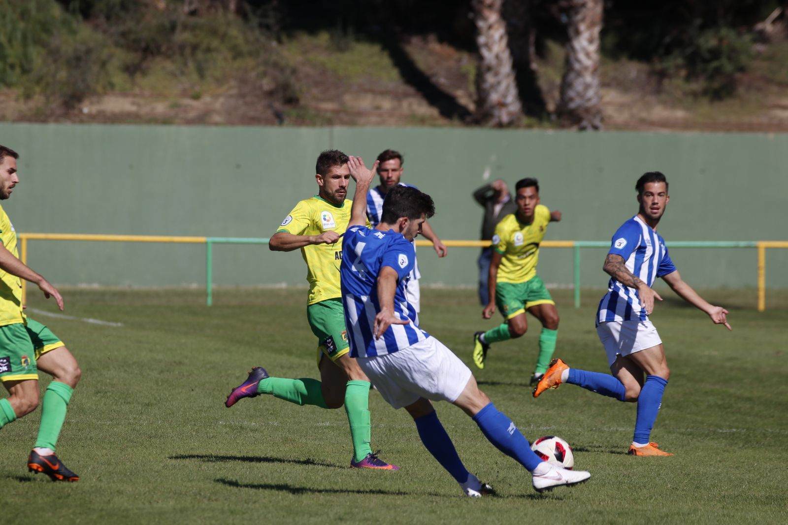 Cote golpea el balón ante la presión de Álex Vázquez