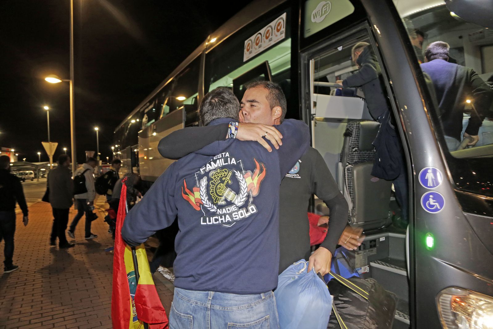 Dos agentes se abrazan antes de partir la noche de este lunes hacia Madrid.