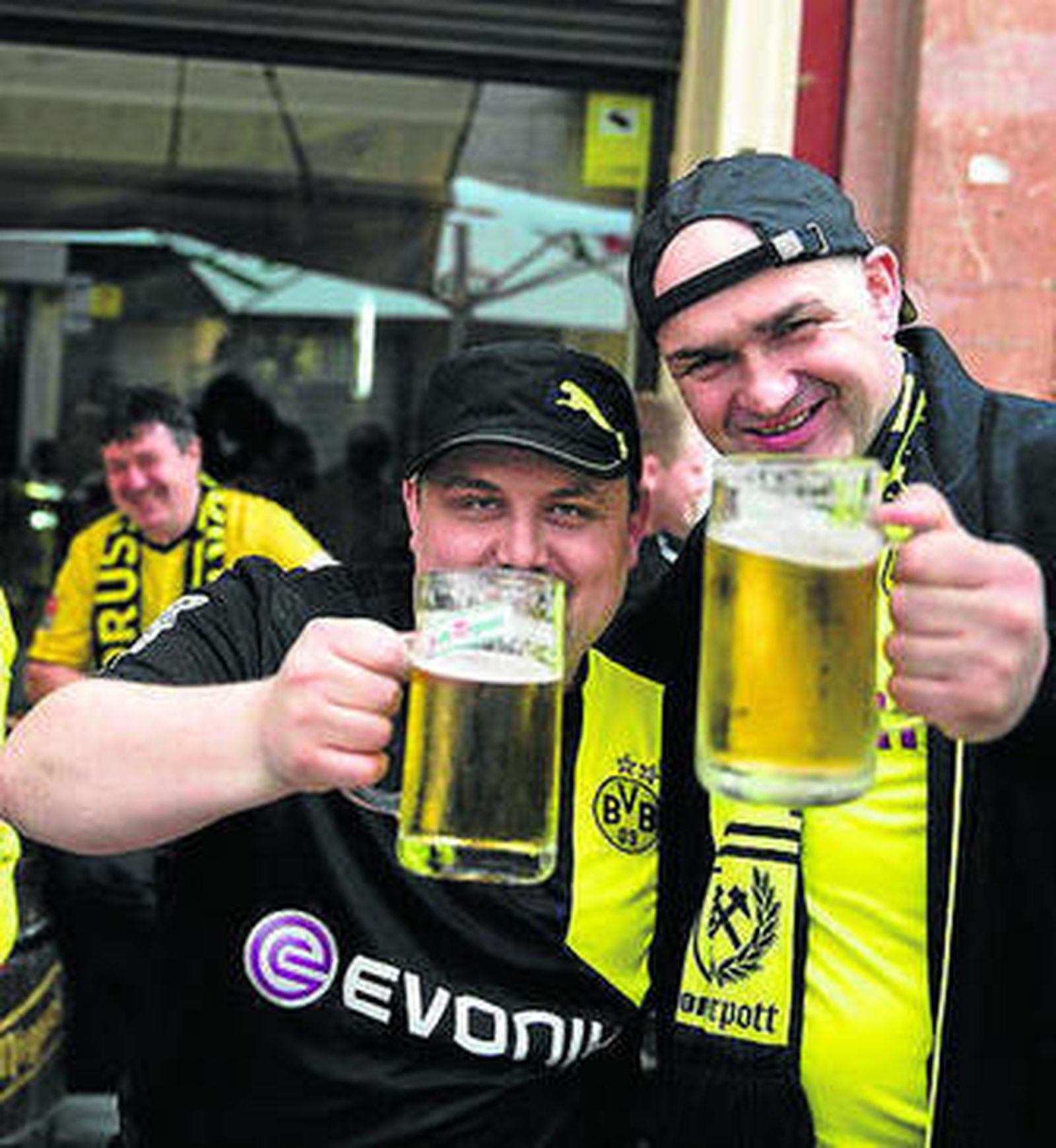 Dos aficionados alemanes brindan con cerveza.