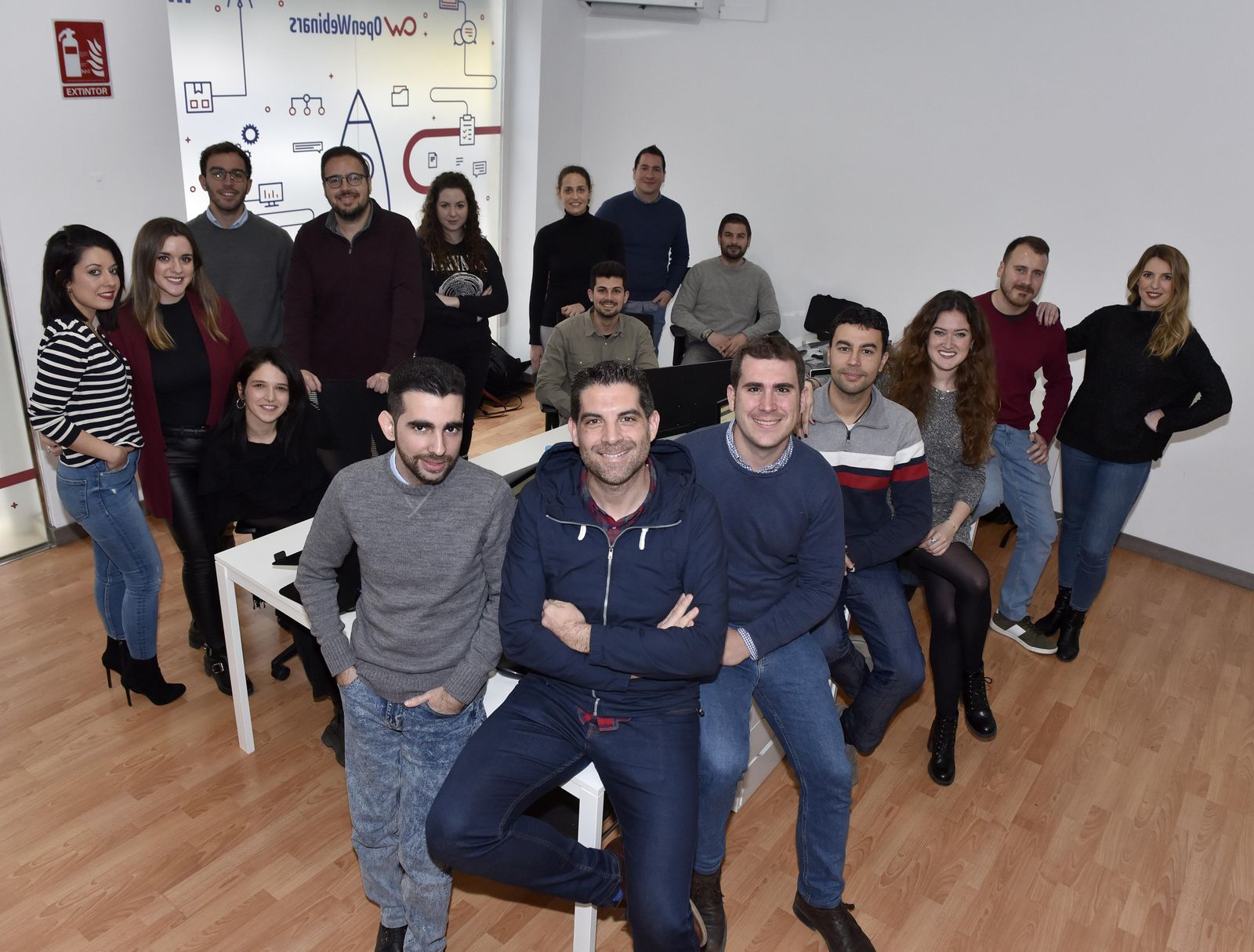 Los tres fundadores de OpenWebinars, delante, escoltados con gran parte de su equipo de trabajo, en su sede de Sevilla.