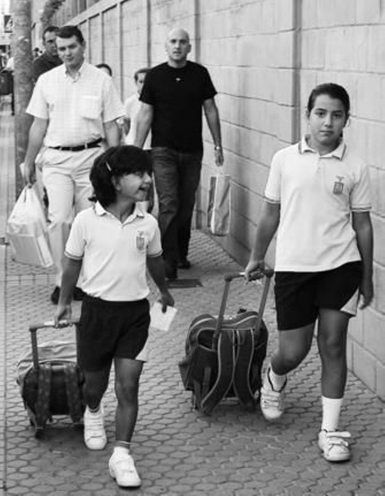 Dos niñas, acompañadas ayer por sus padres, ante el primer día de clase.