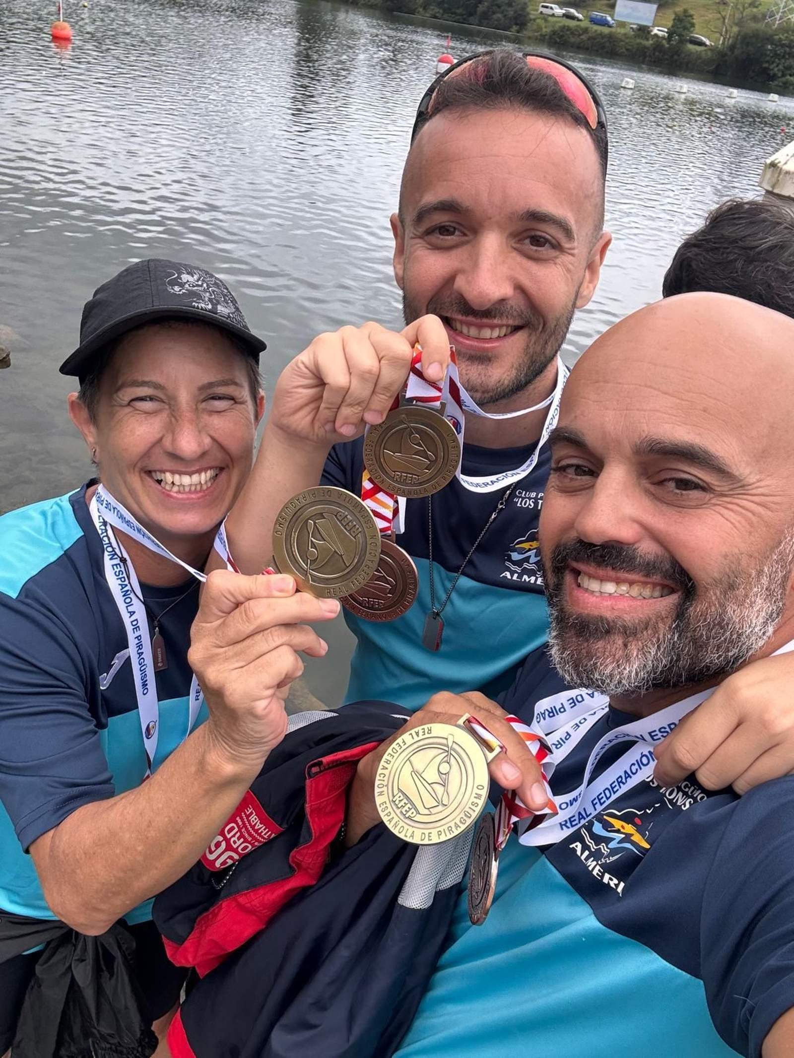 Los medallistas posan sonrientes tras la victoria.