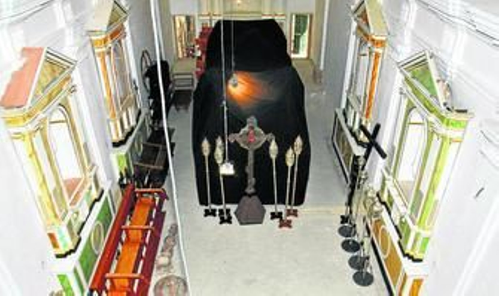 1. Vista parcial del interior de la capilla con todos los retablos readosados a excepción del mayor. 2. Algunos de los faroles que forman el cortejo procesional de la hermandad durante el Martes Santo. 3. El paso del calvario de la Vera Cruz junto a la cruz de guía y otras insignias trasladadas debido al deterioro del almacén. 4. Cestas que utilizan los hermanos para portar el incienso y las velas durante la procesión.