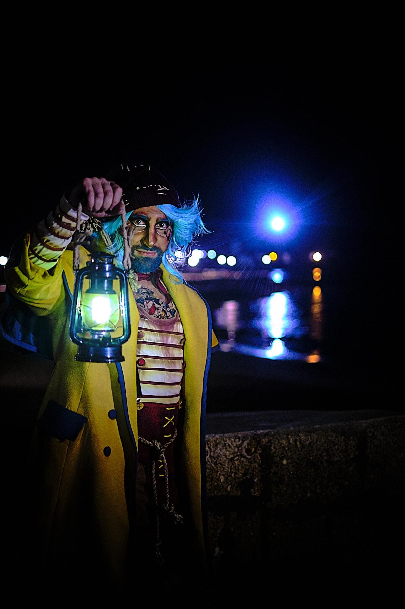 Un componente de la comparsa 'Los Luceros', posa con el tipo frente al Faro de San sebastián.
