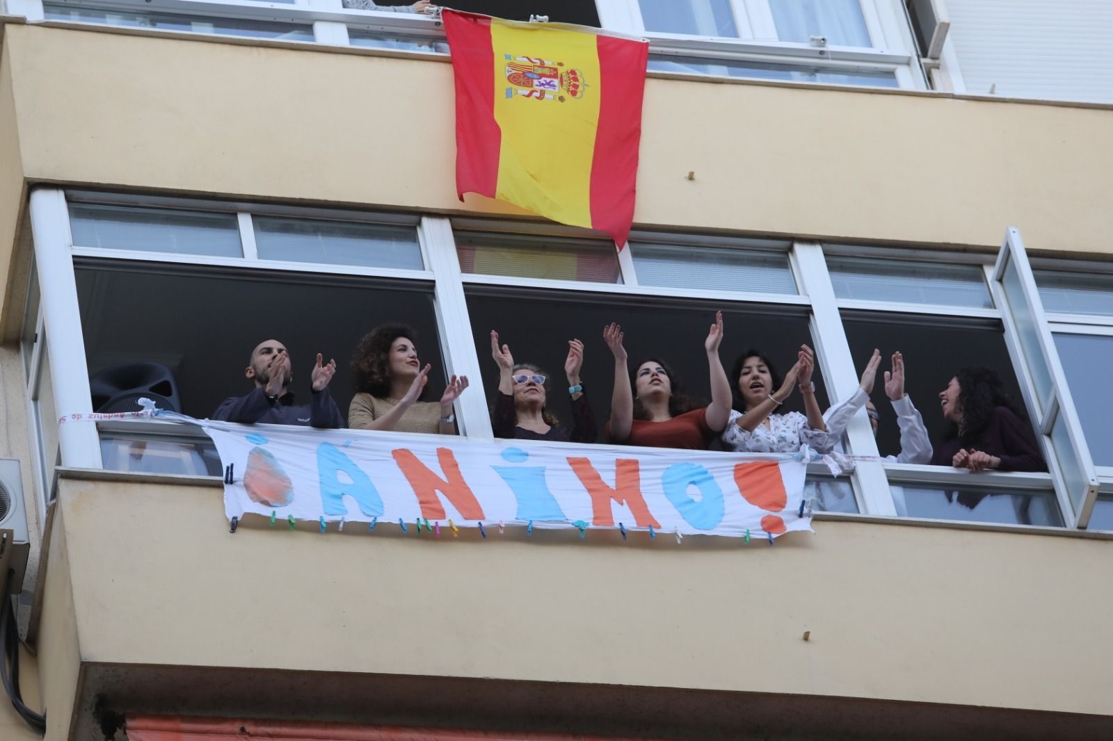 Integrantes de la familia Peláez Romero se asoman al balcón para aplaudir.