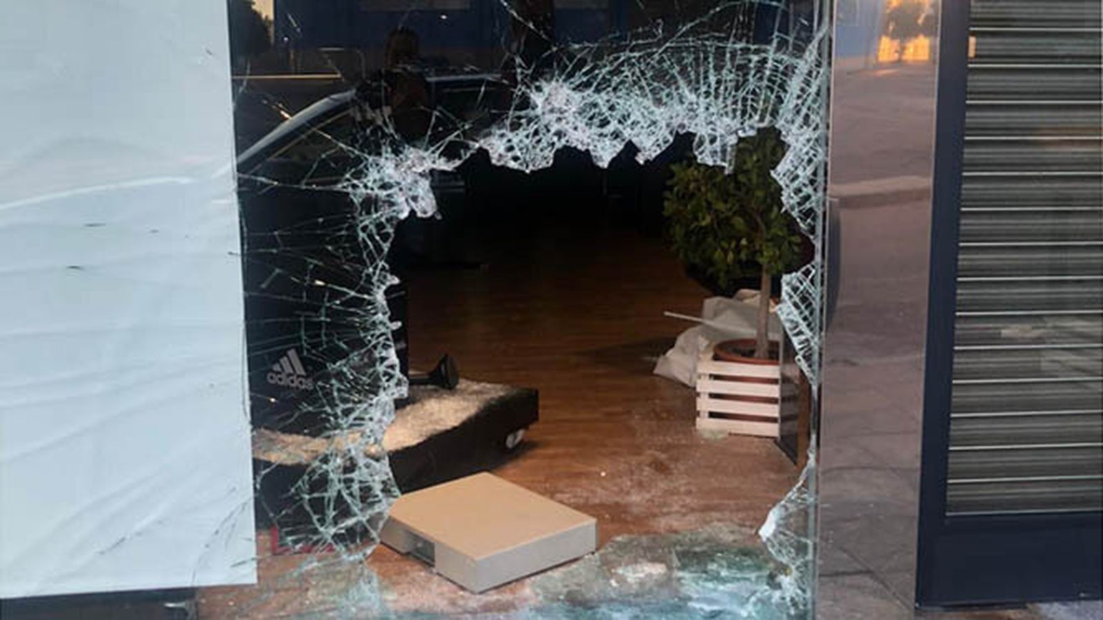 Escaparate destrozado en la tienda de Deportes Alcalá de Lucena.