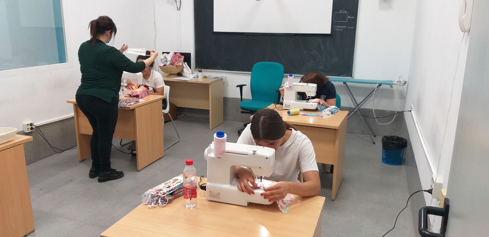 Varias jóvenes del CIMI Sierra Morena, en pleno proceso de elaboración de mascarillas.
