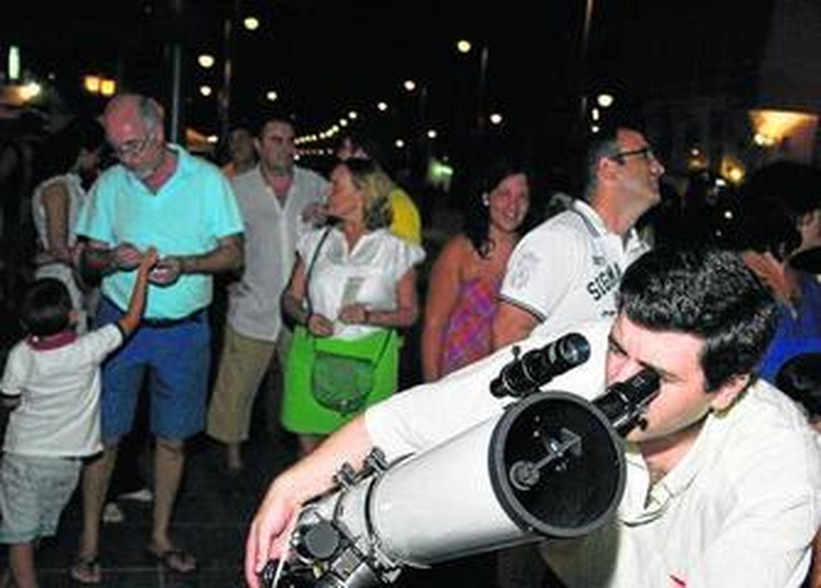 Un grupo de personas disfrutan de una velada astronómica.