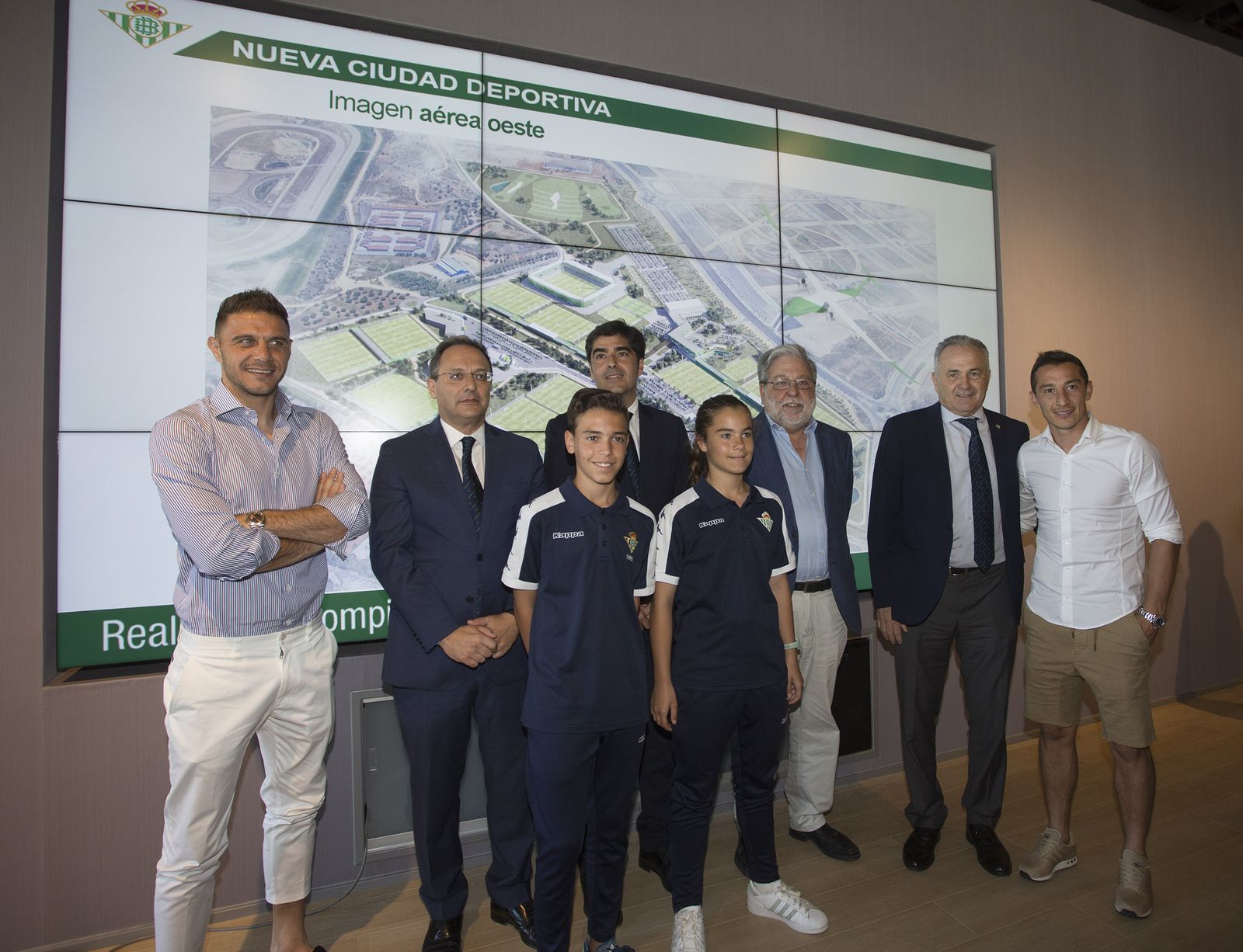 Joaquín, Ozgur Unay, Ángel Haro, Francisco Toscano, alcalde de Dos Hermanas,  Guardado y dos jóvenes canteranos posan con la nueva ciudad deportiva de fondo.
