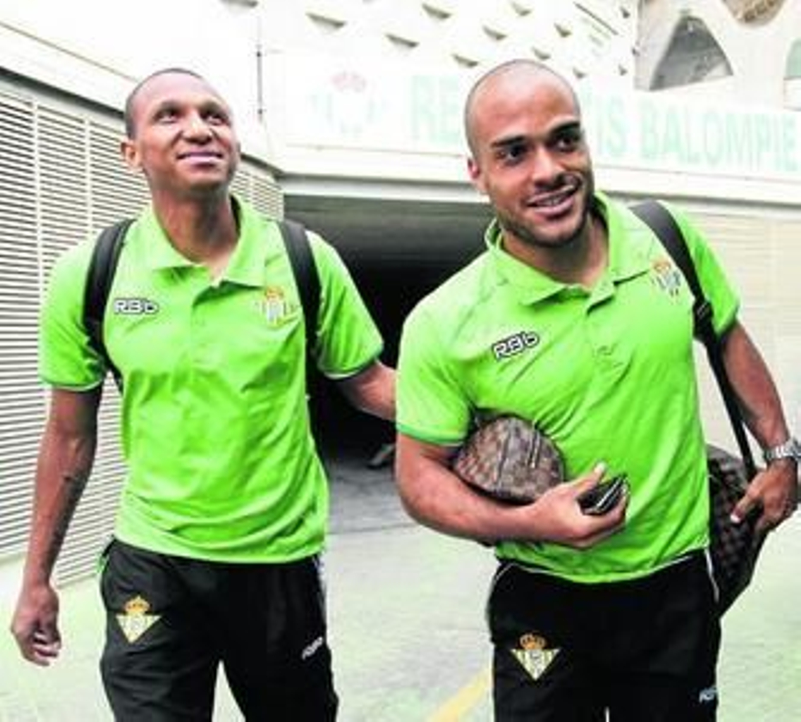 Mehmet Aurelio y Odonkor se disponen a subir al autobús del Betis.