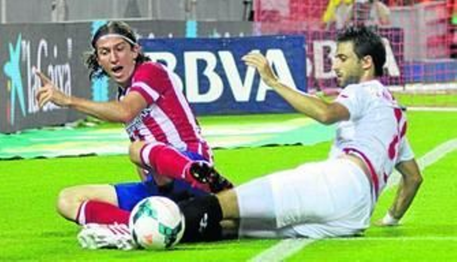 Filipe Luis y Pareja, tras pelear por un balón que ya está fuera del campo.
