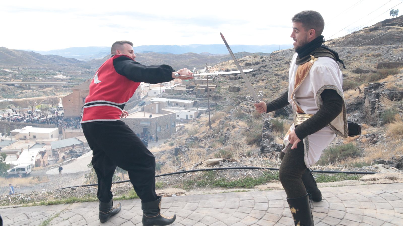 Dos jóvenes escenifican una batalla entre Moros y Cristianos.