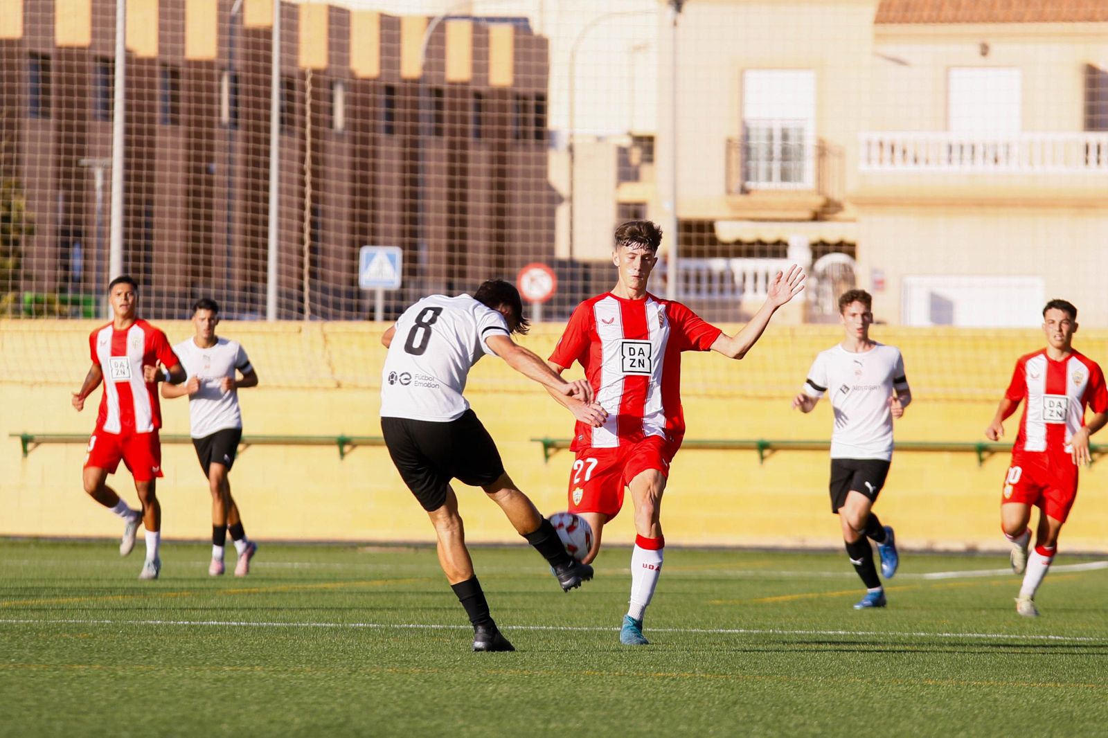 El cañaero Adrián Felipe despeja un balón ante la presión del rojiblanco Fran Rodríguez en el derbi almeriense disputado en el Francisco Pomedio.