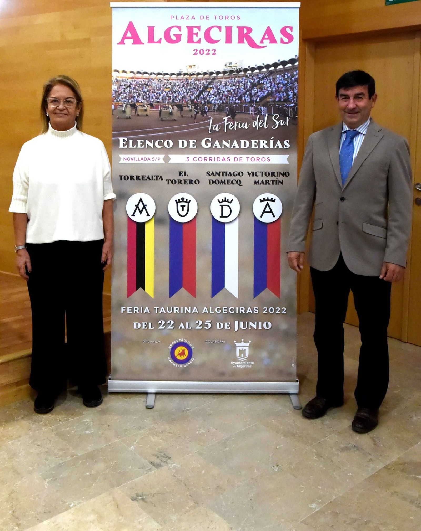 Juana Cid y Carmelo García, con el cartel de ganaderías.