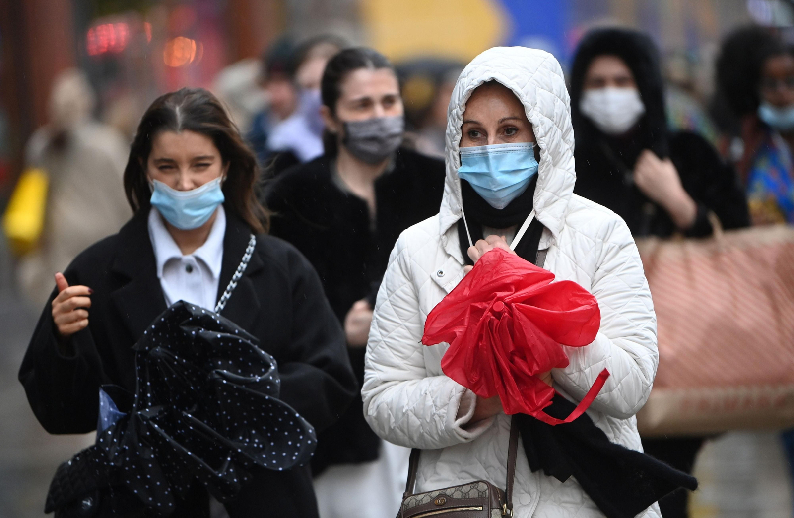 Un grupo de mujeres llevan mascarilla en la calle