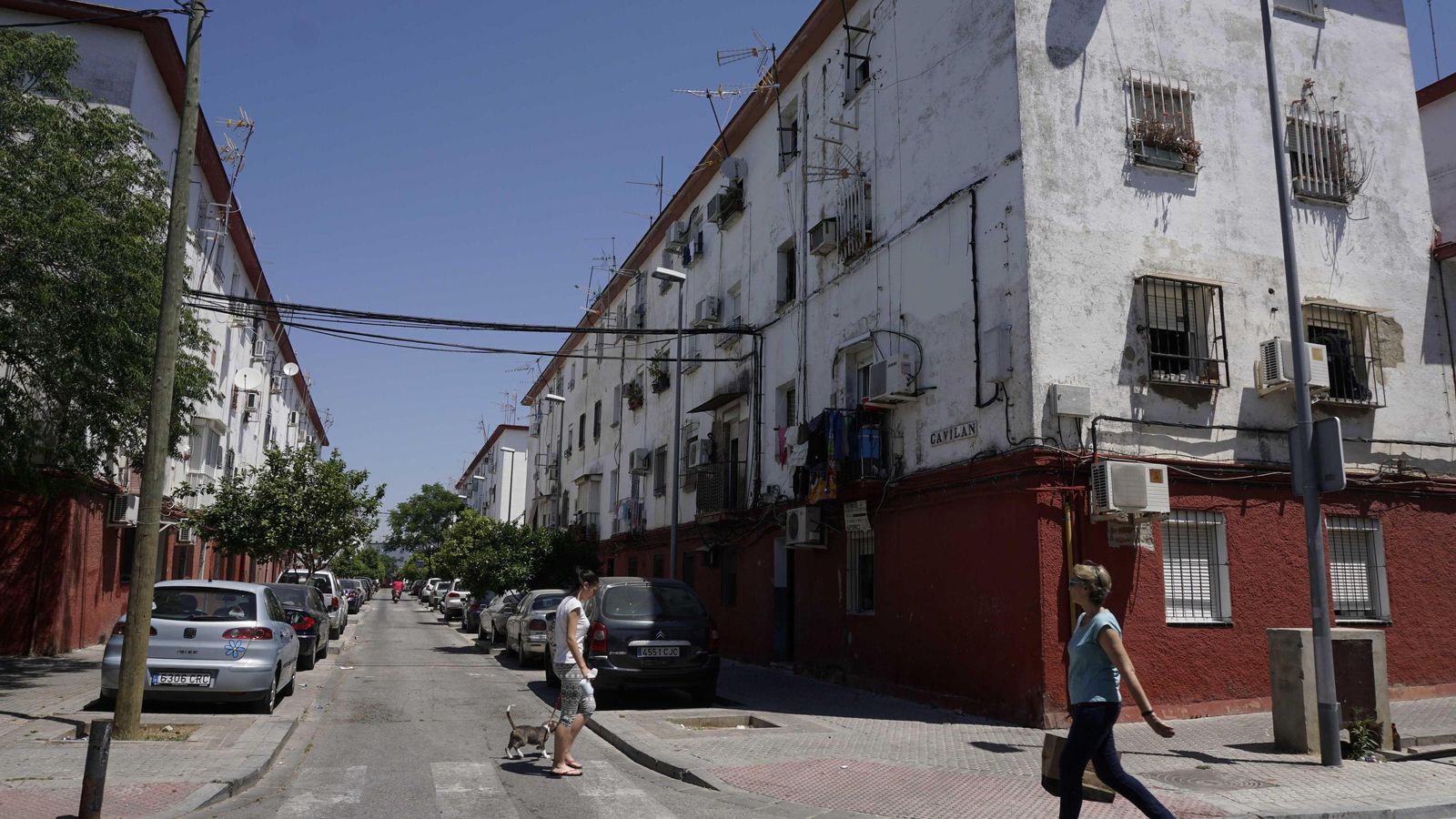 Dos personas caminan junto a bloques deteriorados de Los Pajaritos.